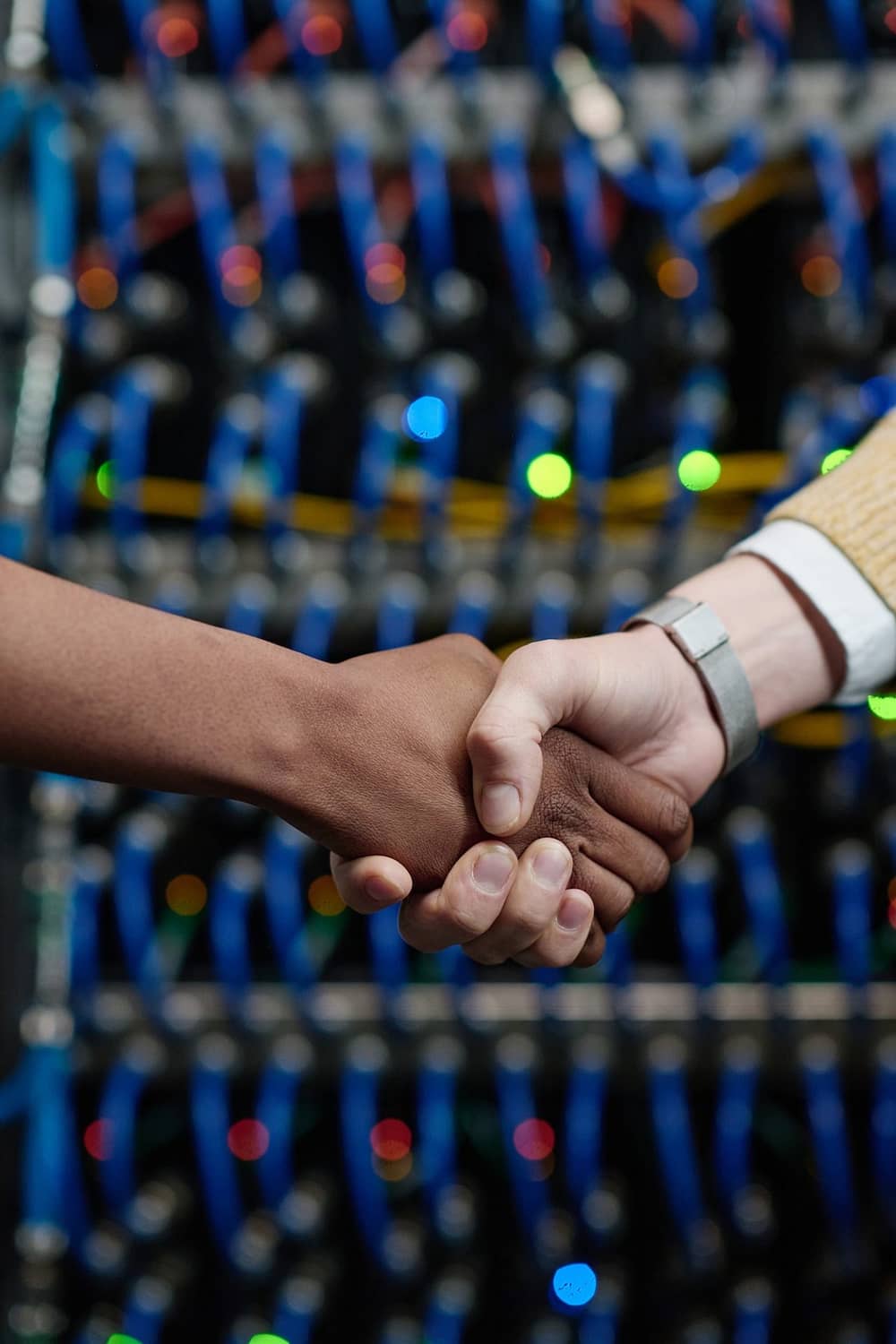 Server engineers shaking hands at office